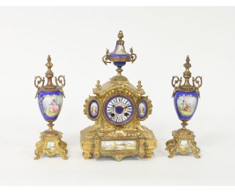 A gilt metal and porcelain mounted eight-day clock set, the clock with urn finials and female bust portrait ovals to the side