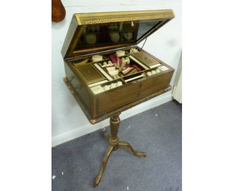 A Cantonese lacquer work box, circa 1820, covered in gold leaf design and with central pagoda panel, containing boxes, pots, 