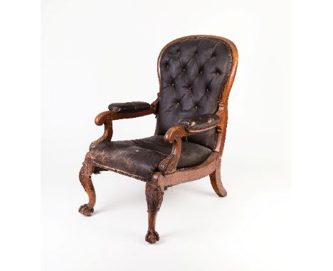 A George IV reclining oak library armchair by R Daws, with adjustable mechanism, on carved front legs with claw and ball feet
