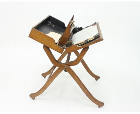 An Edwardian oak folding desk with fitted interior containing stationery rack and inkwell, 61cm wide