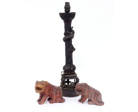 A Chinese metal lamp stand and two carved soapstone tigers