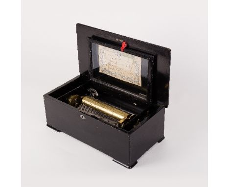 A 19th Century musical box in a walnut case, the hinged cover inlaid musical instruments and foliage, fitted a 23.5cm cylinde