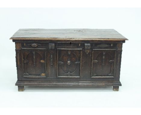 A late 17th Century oak coffer, the planked top above a triple arch panel front with applied split baluster decoration, on bl