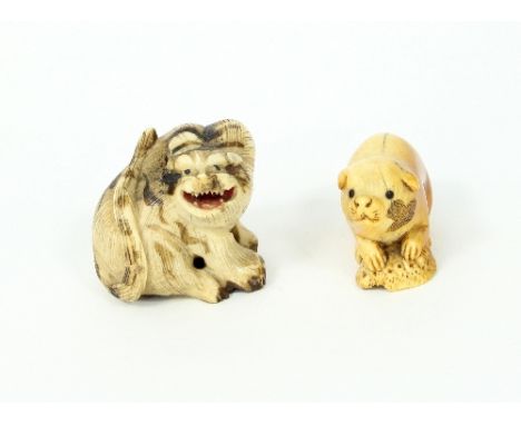 Two Japanese ivory netsuke of tiger and puppy