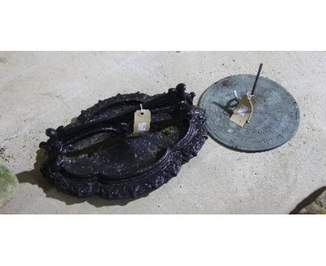 A quatrefoil cast iron boot scraper and a sundial 