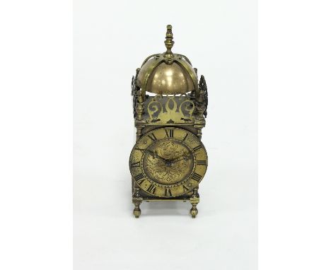 A brass lantern type clock Condition Report: The clock does not strike, the bell is decorative only 26cm high.
