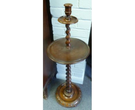 An oak candlestick with spiral column and circular base