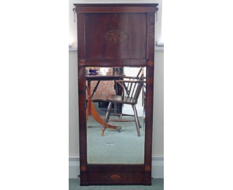 An early 19th Century mahogany pier glass with chequer inlaid cornice above a deep panel frieze inset a marquetry oval decora