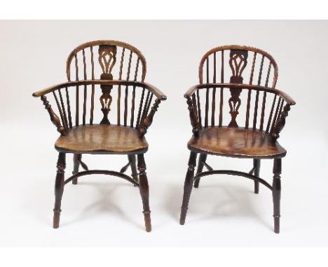 A matched pair of 18th Century yew and elm wood Windsor type armchairs with stick and pierced splat backs on turned baluster 