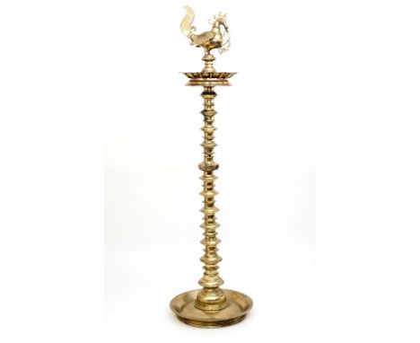 A very large 19th Century Deccan standard oil lamp topped with a cockerel cast reservoir above a thirteen light tray on multi