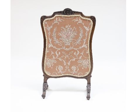 A Louis XV style walnut firescreen of cartouche shape, on scrolling leaf carved base, 105cm high