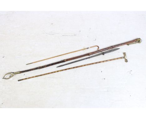 Group of four bamboo walking stick canes to include one metal spiked example and a brass ended reach extender