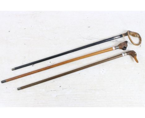Walking stick, the handle in the form of coiled snake, with yellow glass eye, the hardwood cane with hallmarked silver mount,