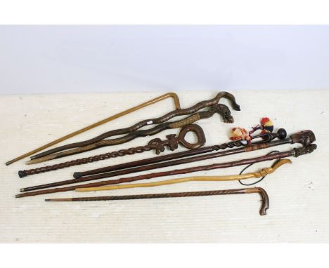 Assorted collection of 20th Century walking sticks to include African carved hardwood examples, a selection of carved Cobra s