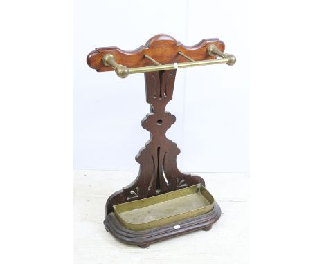 Early 20th century mahogany and brass umbrella stick stand with shaped back stand, raised tray and brass handle support, H 79
