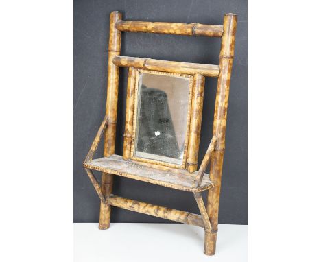 Victorian aesthetic movement bamboo framed mirror shelf having mirror to centre with shelf below. Measures 57 x 34cm.