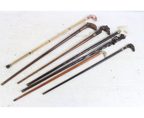 Collection of seven walking sticks, to include: a pottery horse head example, an early 20th century hardwood stick, the handl