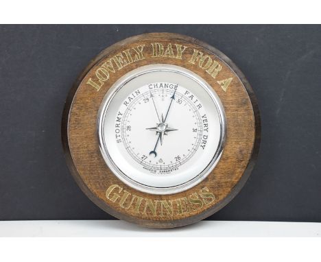 A Guinness 'Lovely Day For A' advertising wall mounted barometer.