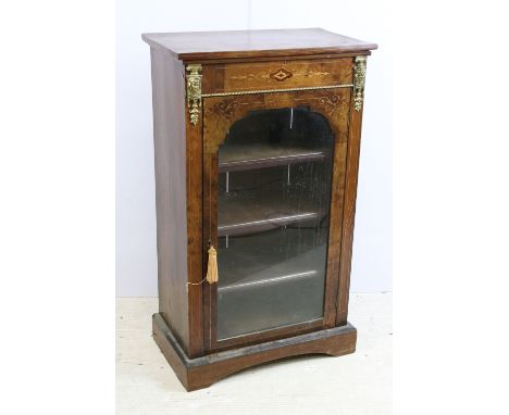Edwardian walnut and rosewood inlaid music / drinks cabinet, with single glazed door flanked by gilt metal mounts, four shelv