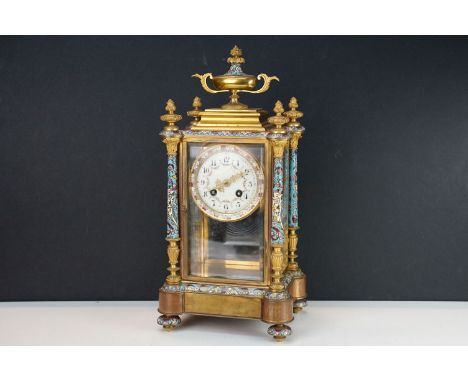 Late 19th Century French glass cased mantle clock having cloisonne enamelled columns and outer dial, with a urn finial to top