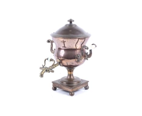 A 19th century copper samovar. The circular body with an engraved lift off lid and the original detailed knob, with two ceram