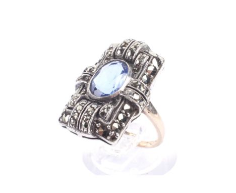 A vintage oval blue paste and marcasite rectangular cluster ring in Art Deco style. The stones all set in a white metal head 