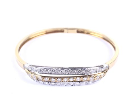 A vintage Italian 18ct white and yellow gold and diamond three row bangle. The openwork front designed as a row of thirteen r