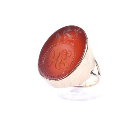 A vintage gold signet ring set with a Victorian oval carnelian intaglio. The carnelian approx, 24.9mm x 18.5mm, with a oval r