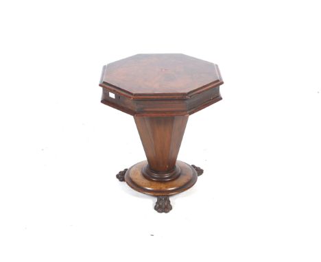 A Victorian rosewood work table. The octagonal top enclosing a fitted interior, the tapering octagonal drum mounted on a circ