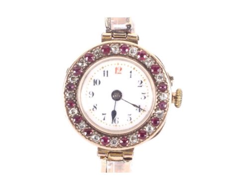 A lady's 9ct gold, ruby and diamond set bracelet watch, circa 1911. The white enamelled dial with a red 12 and black Roman nu