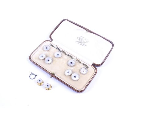 An early 20th century gold, mother of pearl and sapphire round dress set. Comprising; a pair of twin-panel cufflinks with cha