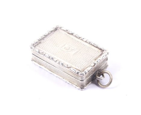 An William IV silver engine turned vinaigrette. With raised floral chased borders, reeded sides and a central rectangular res