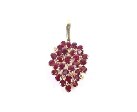 A vintage ruby and diamond pendant in the form of a stylised leaf-cluster drop. Claw set with 27 oval mixed-cut rubies and wi