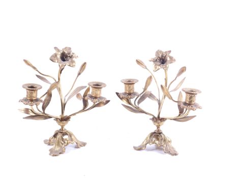 A pair of gilt metal 'Art Nouveau' style candelabra. In the form of a growing flower, two branches with leaves and buds. Rais