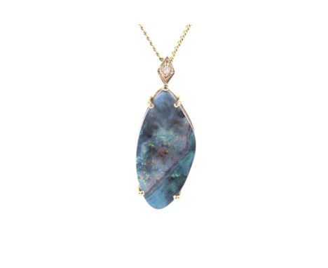 A boulder opal pendant and chain. The abstract-shaped boulder opal panel displays a mostly green and orange play of colour, i