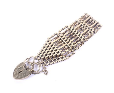 A vintage 9ct gold eight-bar 'gate' bracelet. On a foliate-engraved heart-shaped padlock clasp with hallmarks for London 1968