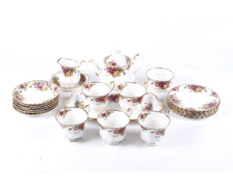 A Royal Albert 'Old Country Roses' pattern tea service. Comprising a teapot, five cups, six saucers, a sugar bowl, cream jug,