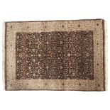 A brown ground rug with cream decoration.