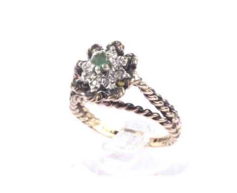 A vintage 9ct gold, emerald and diamond cluster ring. Centred with a small round emerald within a tiny diamond eight stone su