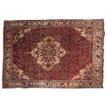 An Orico Persian style silk rug.