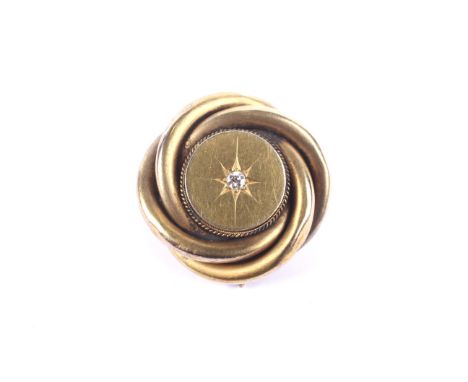 A Victorian gold and diamond locket-back brooch.The central round panel star-gypsy set at the centre with an old-cut diamond 