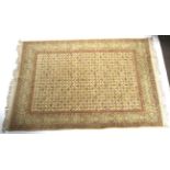 A yellow ground rug with flower decoration. Surrounded by a geometric border and tassles.