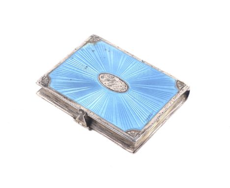 An early 20th century silver and pale-blue guilloche enamelled book-shaped pocket pill box or snuff box. The hinged front wit