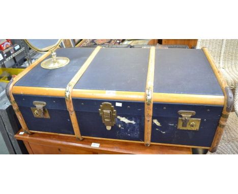 A wooden banded blue painted travel trunk