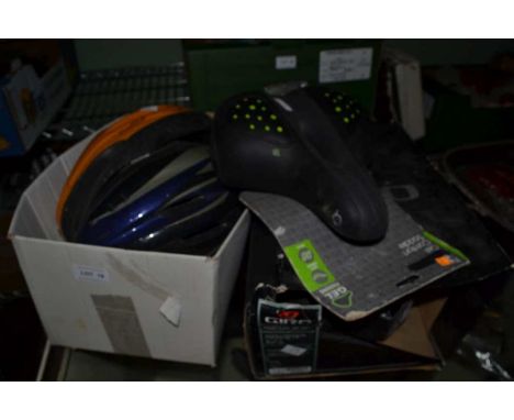 Three bike safety helmets and a gel saddle
