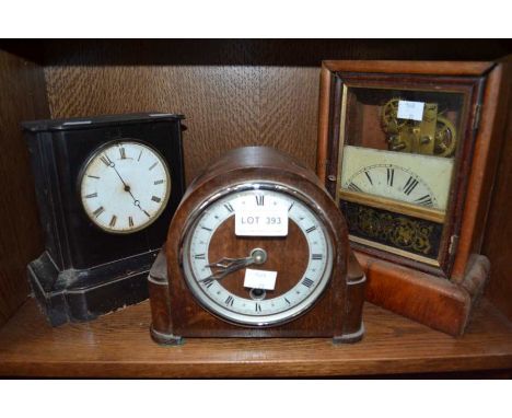 A black marble mantle clock with tow other similar examples