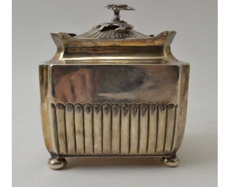 A Victorian silver tea caddy, fluted body, with hinged cover having floral knop, raised on four bun feet, 218g