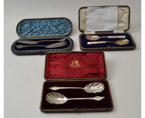 Three cased sets of silver food serving implements includes a pair of silver jam spoons with mother-of pearl handles