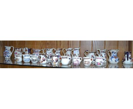 A shelf of small sized jugs - mainly 'Masons'