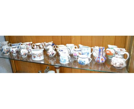 A shelf of small sized jugs - mainly 'Masons'